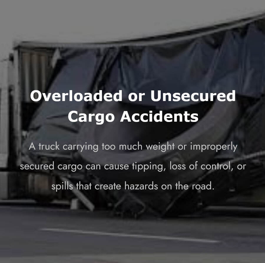 A commercial truck trailer tipped on its side with cargo spilling out, illustrating the road hazards caused by overloaded or unsecured cargo truck accidents.