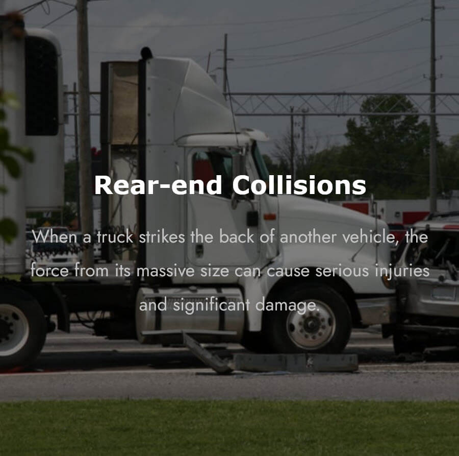 A white semi-truck after striking a vehicle from behind at an intersection, showing the serious damage caused by a commercial truck rear-end collision